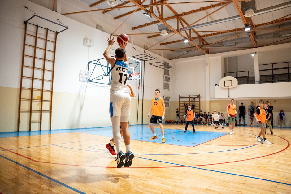 Exciting moment from a basketball game with players in action on an indoor court.
